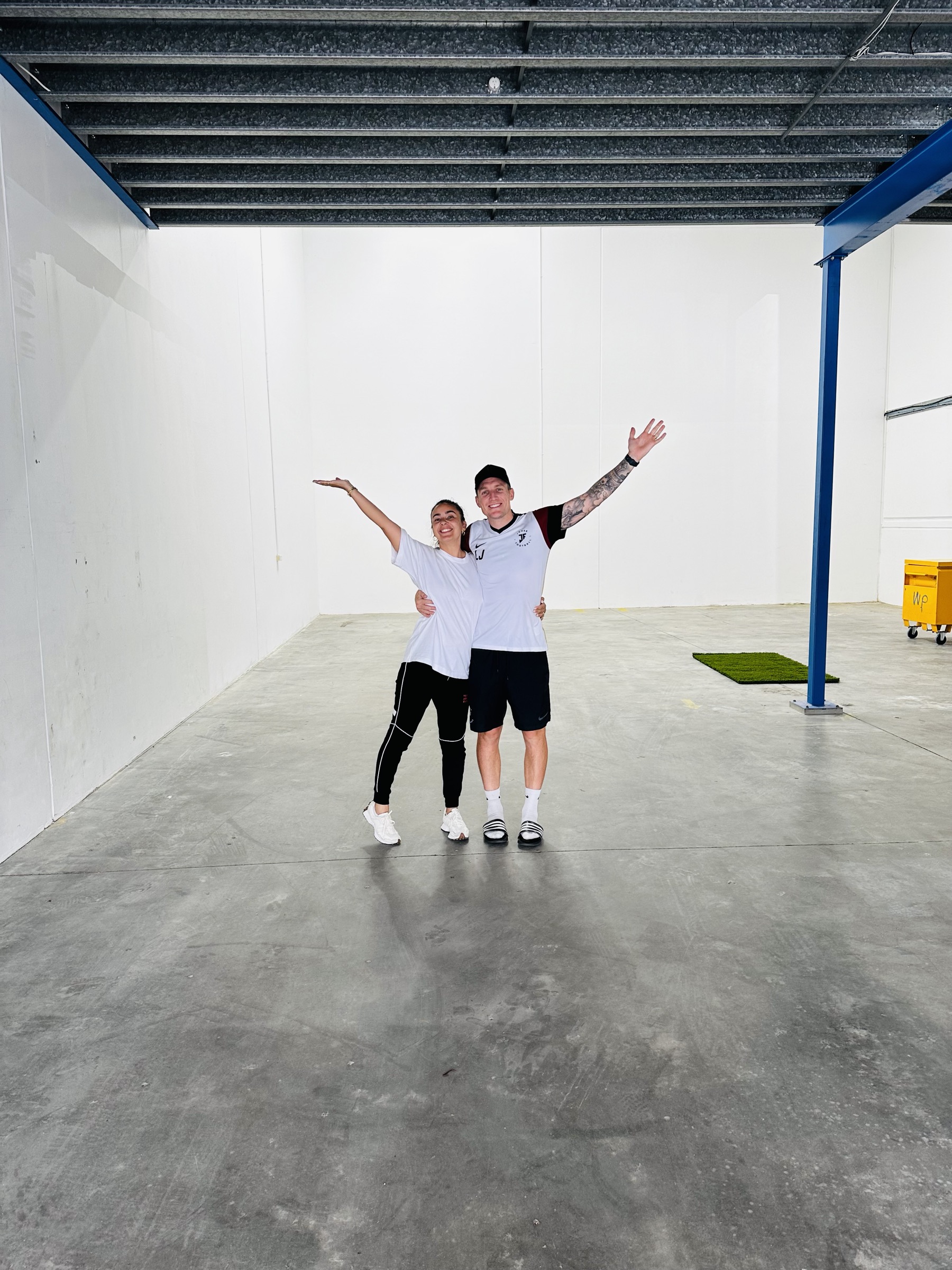 Lee and Carolina inside the empty warehouse that became the Joner Football HQ