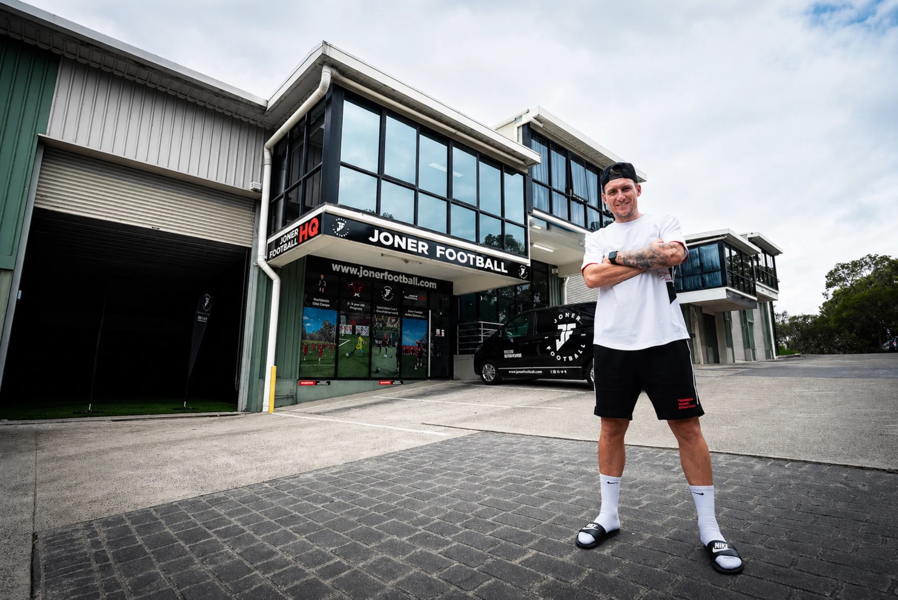 Lee standing outside the Joner Football HQ building in Belrose