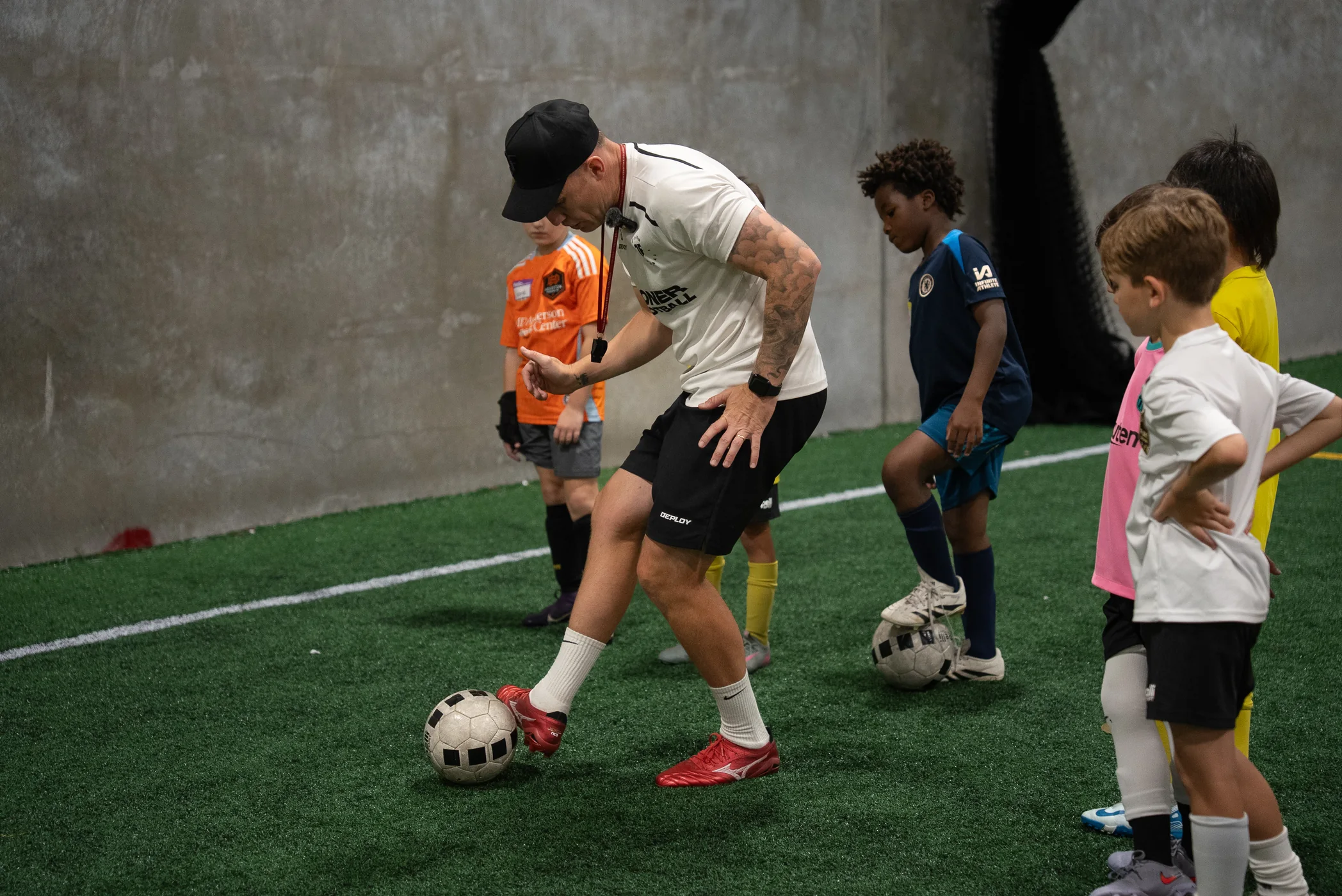 Lee Jones coaching players during an evening Joner Football session