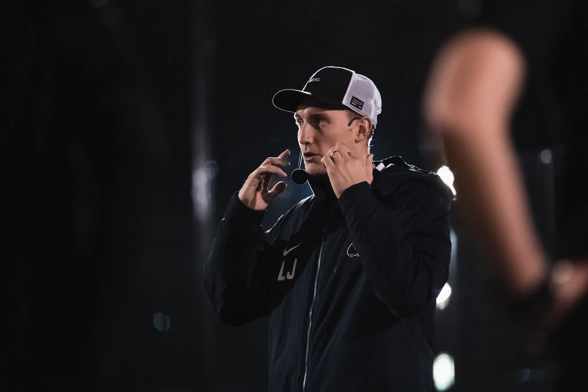 Lee Jones giving coaching detail during a Joner Football session at night